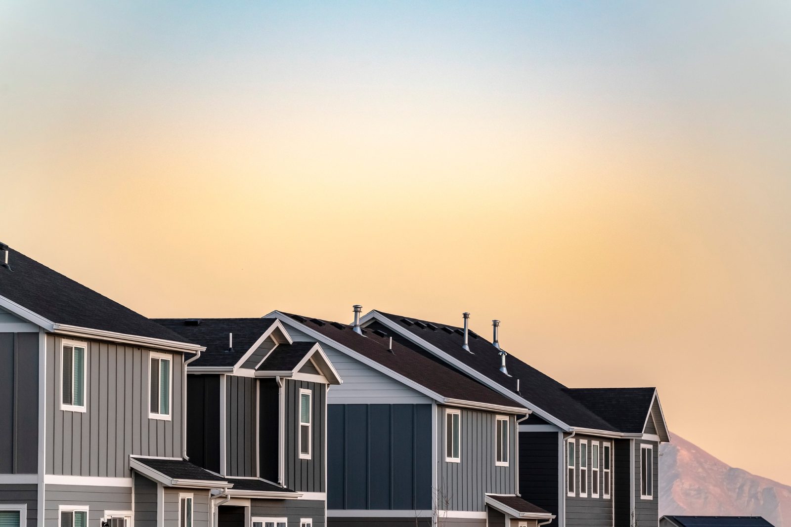 Row of modern two-story homes in a Los Angeles County neighborhood at sunset